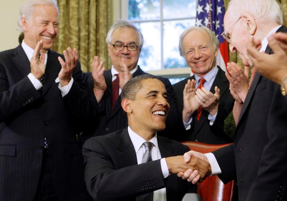 FILE - In this June 17, 2009 file photo, President Barack Obama is congratulated by Franklin E. Kameny, right, after delivering brief remarks and signing a Presidential Memorandum regarding federal benefits and non-discrimination during a ceremony in the Oval Office of the White in Washington. Frank Kameny was out and proud before people knew what being "gay" meant. Fired from his job as a government astronomer in 1957 for being gay, he refused to go away quietly. Instead, he got louder. He took his case to the Supreme Court in 1961 and helped stage the first gay rights march in front of the White House and Philadelphia's Independence Hall in 1965. Kameny died Tuesday at the age of 86, leaving behind a 50-year legacy as an advocate who chipped away at countless other barriers for gay people in America. Kameny served as the initial protester, leader and legal strategist of what would become a movement, one historian said. Applauding from left are, Vice President Joe Biden, Rep. Barney Frank, D-Mass., and Sen. Joseph Lieberman, I-Conn. (AP Photo/Haraz N. Ghanbari, File)